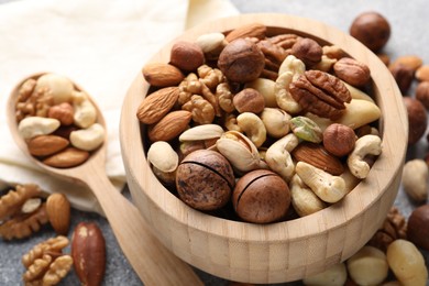 Photo of Mix of different nuts on grey table, closeup