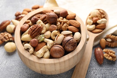 Photo of Mix of different nuts on grey table, closeup