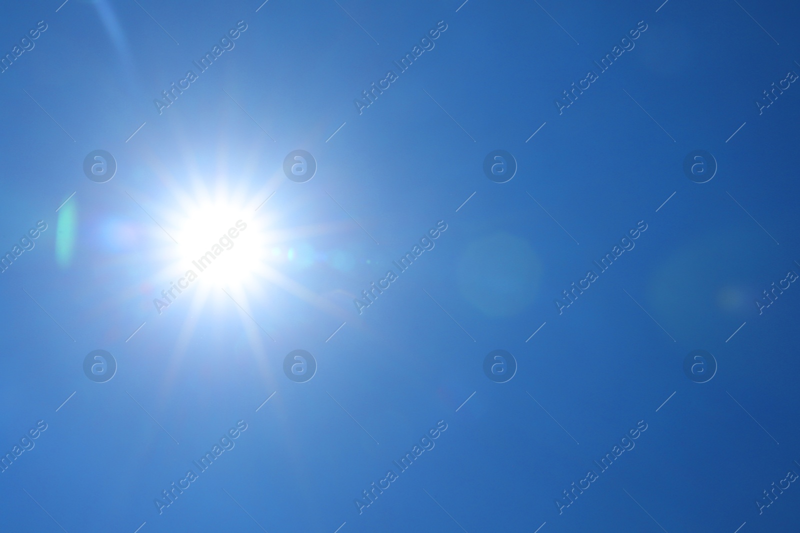Photo of Bright sun on clear blue sky. Good weather