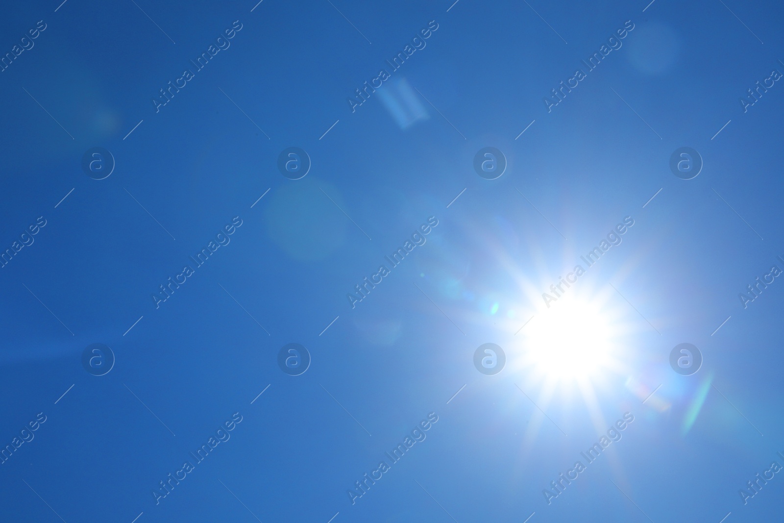 Photo of Bright sun on clear blue sky. Good weather
