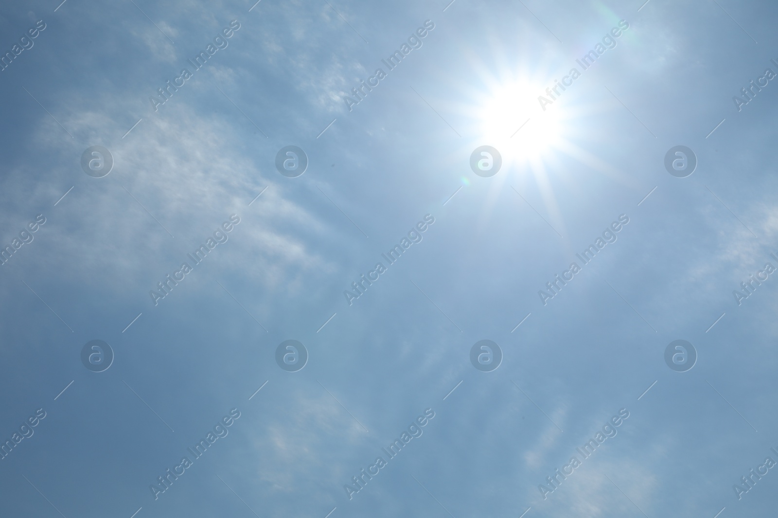 Photo of Bright sun and clouds on light blue sky. Good weather