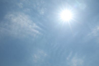 Photo of Bright sun and clouds on light blue sky. Good weather