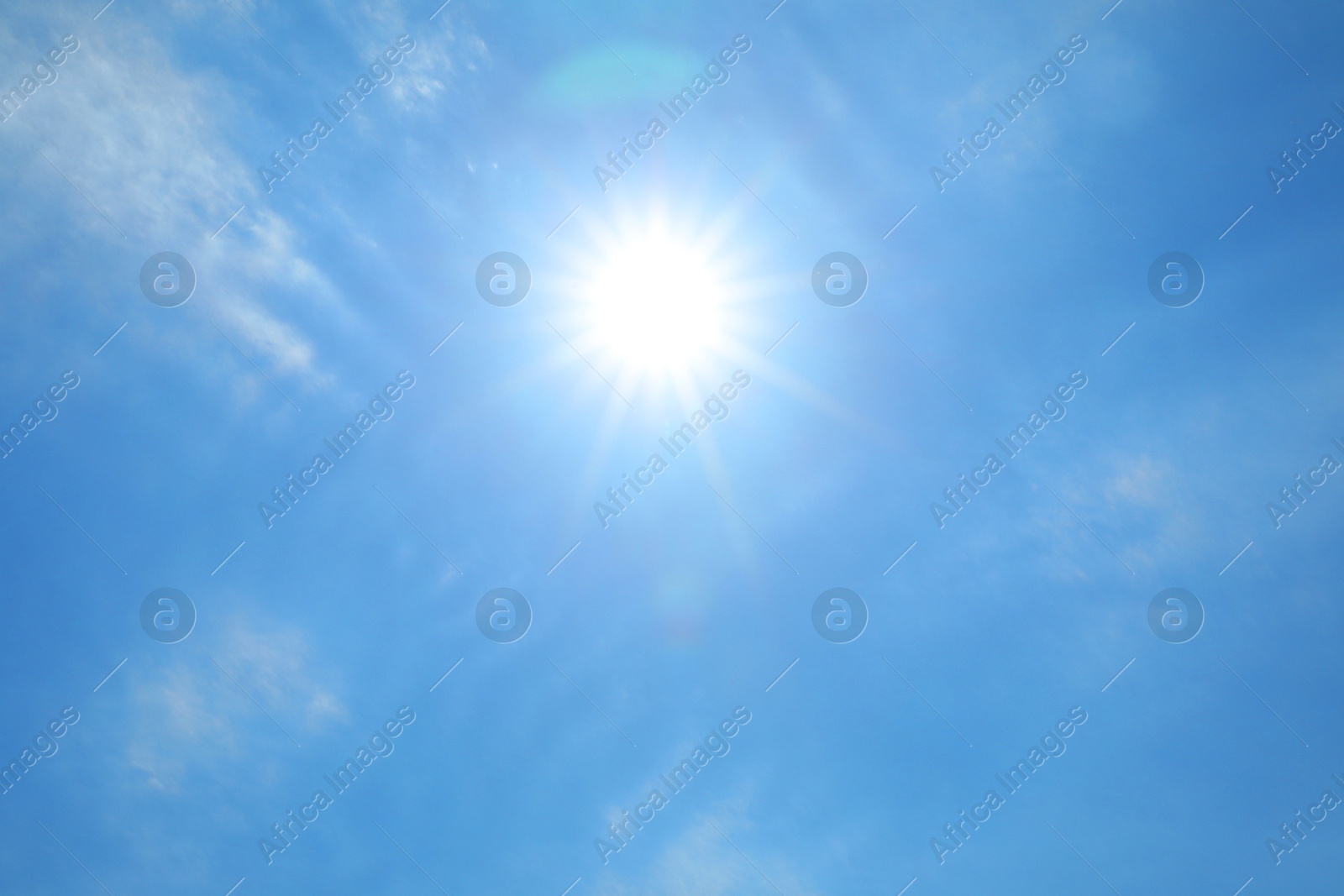 Photo of Bright sun and clouds on blue sky. Good weather