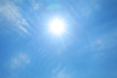 Photo of Bright sun and clouds on blue sky. Good weather