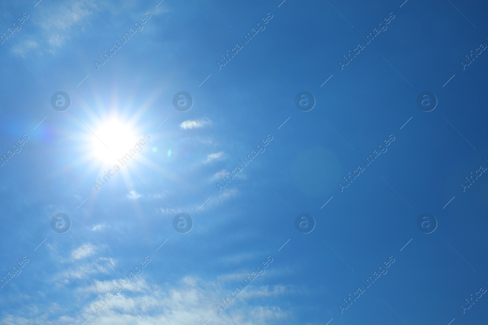 Photo of Bright sun and clouds on blue sky. Good weather