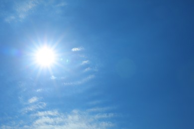Photo of Bright sun and clouds on blue sky. Good weather