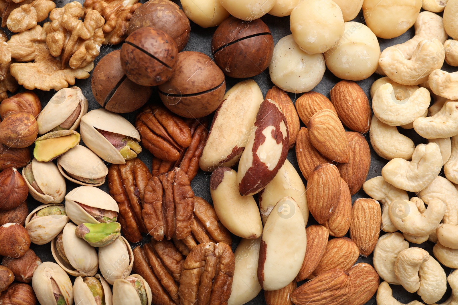 Photo of Mix of different nuts as background, top view