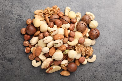 Photo of Mix of different nuts on grey table, flat lay