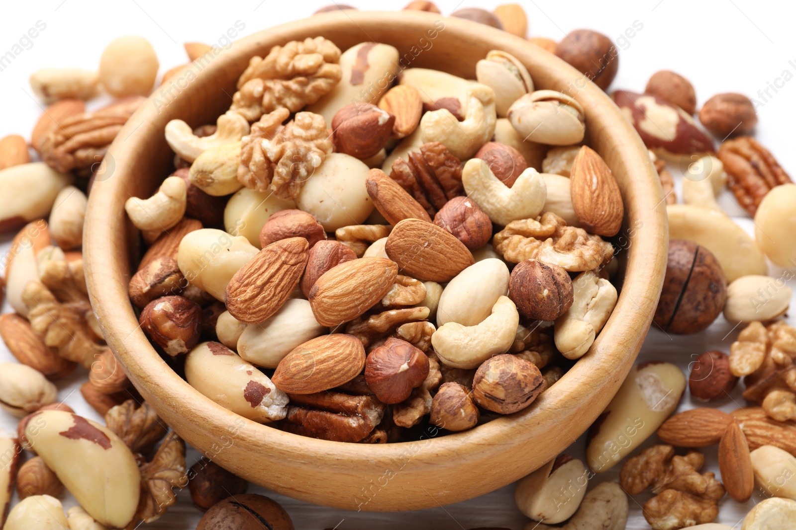 Photo of Mix of different nuts in bowl on table, closeup