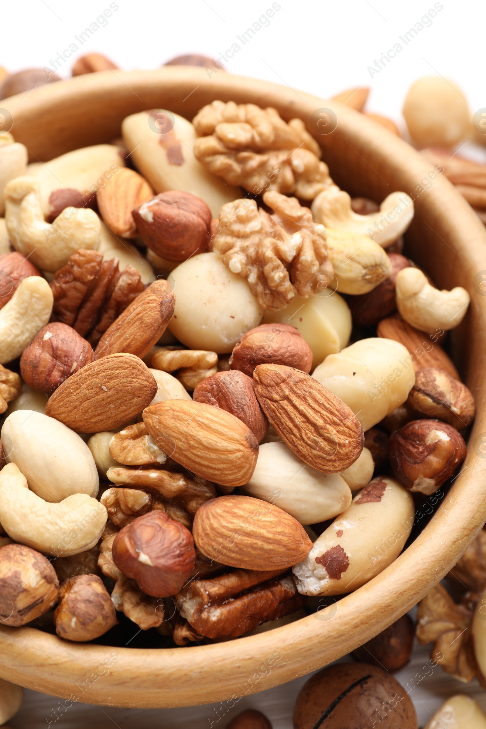 Photo of Mix of different nuts in bowl on table, closeup