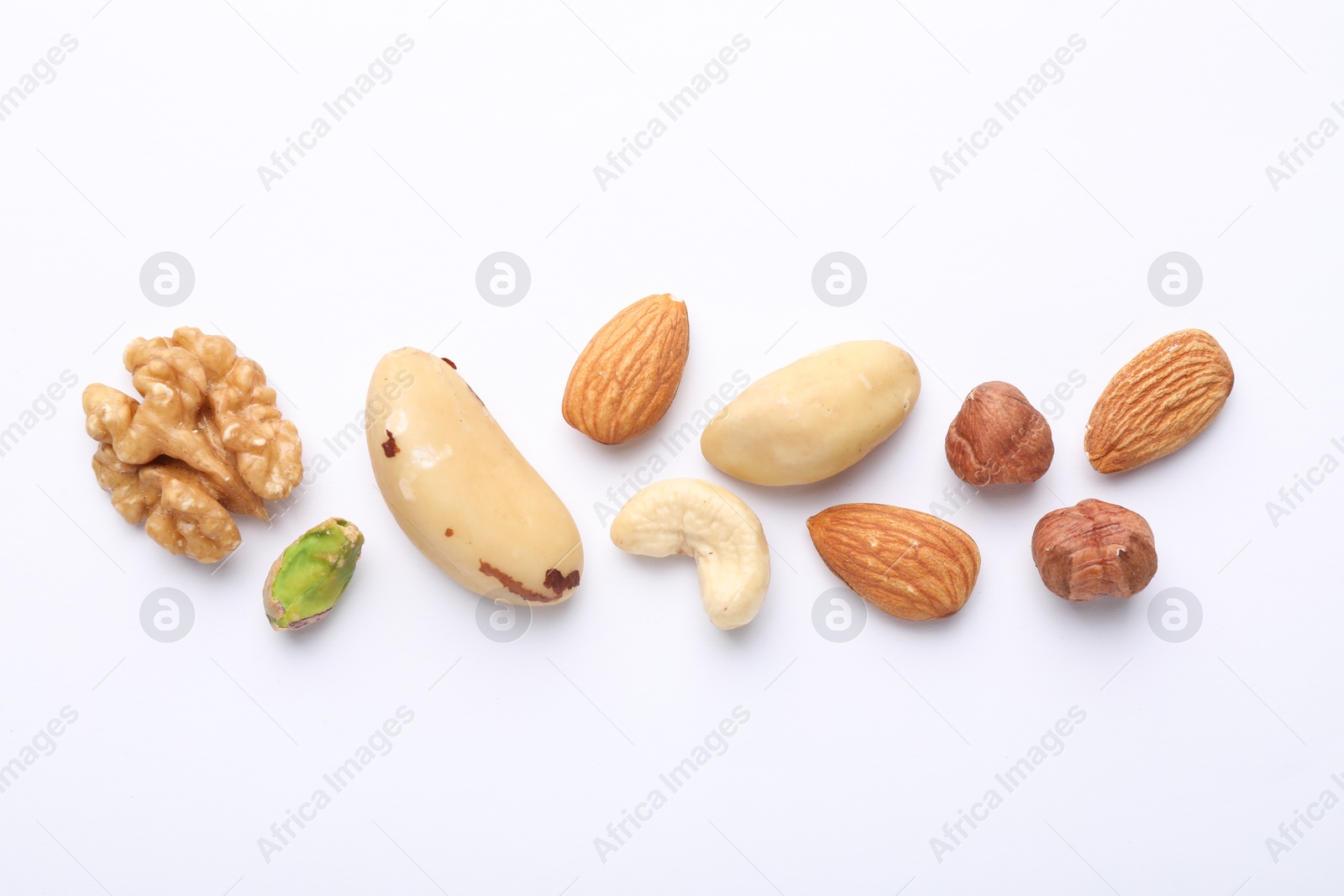 Photo of Mix of different nuts on white background, flat lay