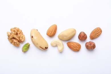 Photo of Mix of different nuts on white background, flat lay