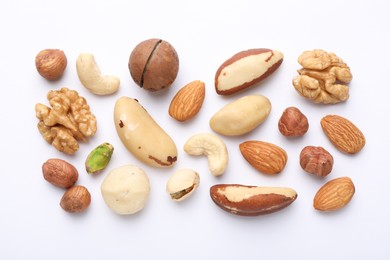 Photo of Mix of different nuts on white background, flat lay