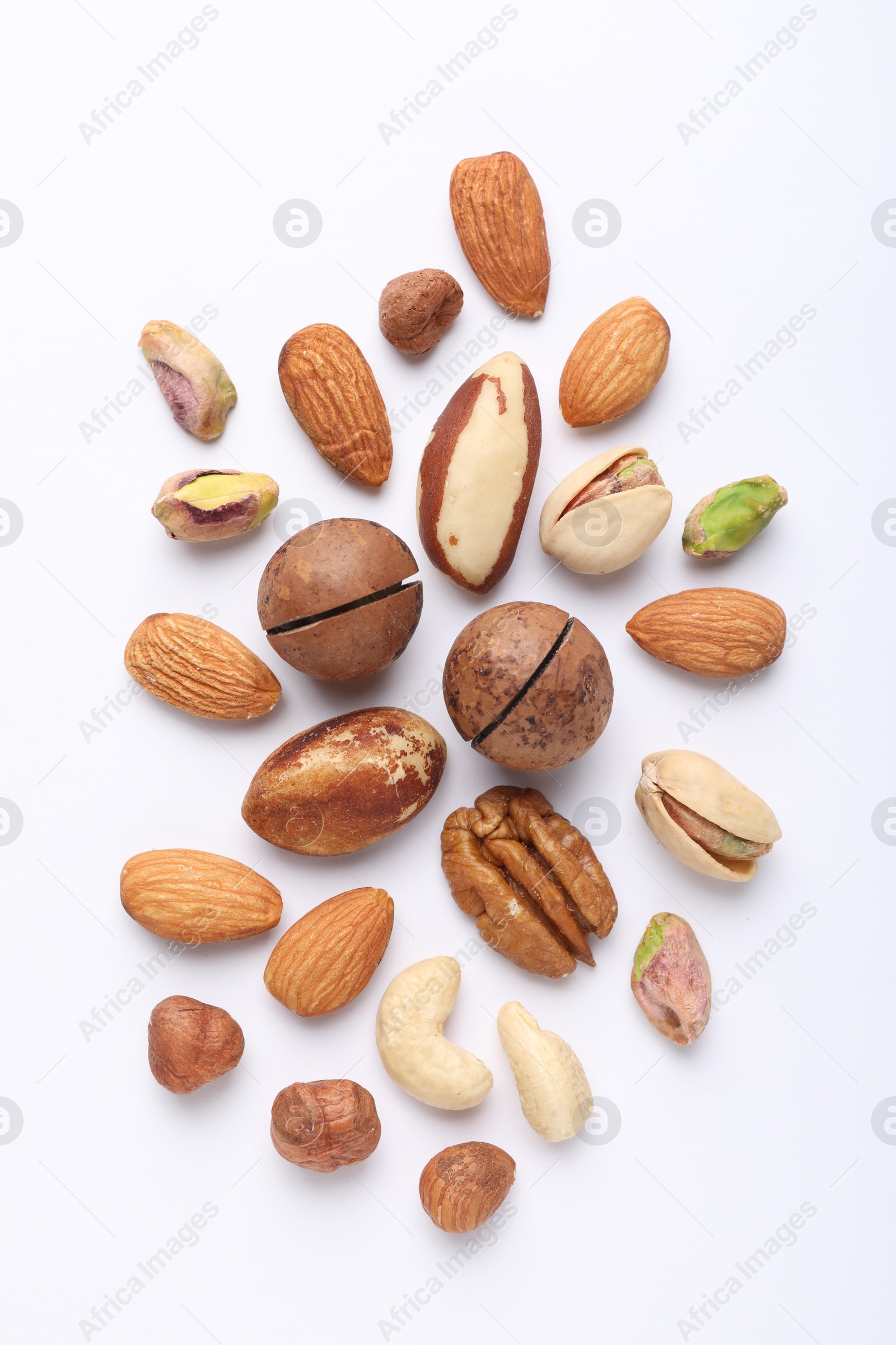 Photo of Mix of different nuts on white background, flat lay