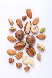Photo of Mix of different nuts on white background, flat lay