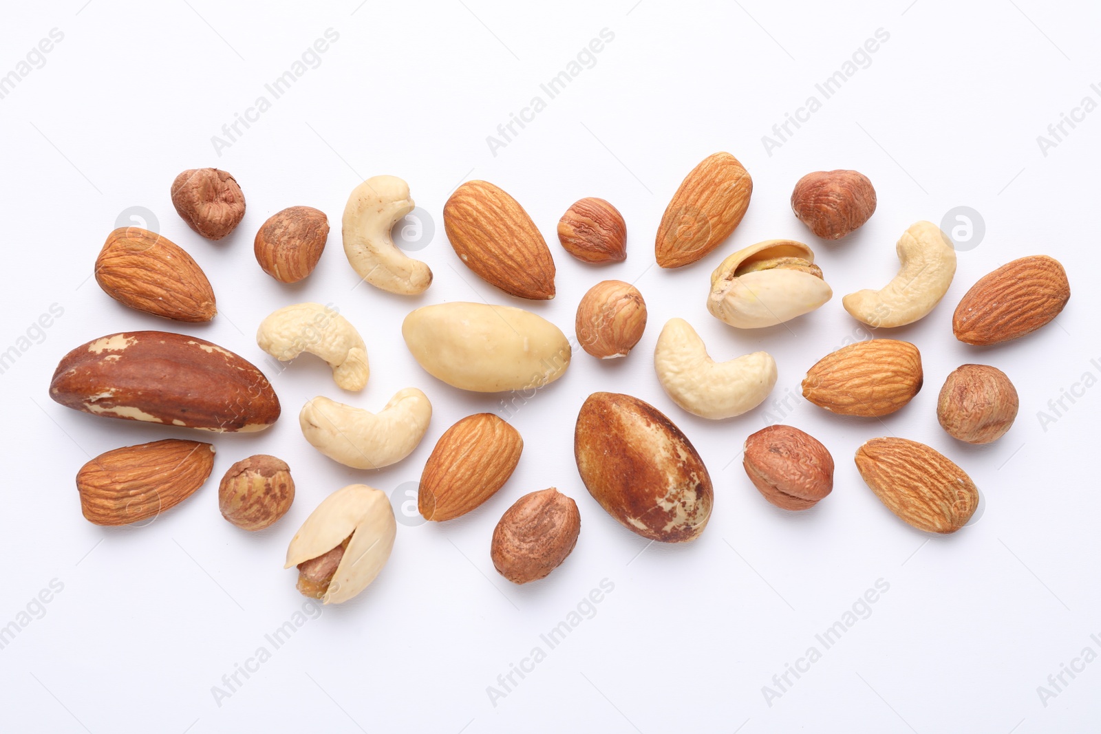 Photo of Mix of different nuts on white background, flat lay