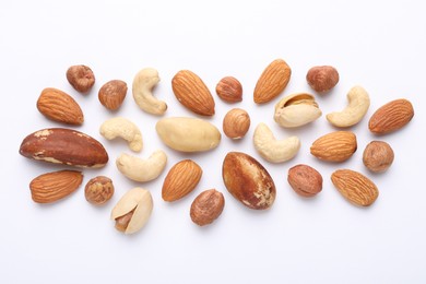 Photo of Mix of different nuts on white background, flat lay