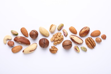 Photo of Mix of different nuts on white background, flat lay