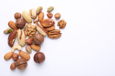 Photo of Mix of different nuts on white background, flat lay. Space for text