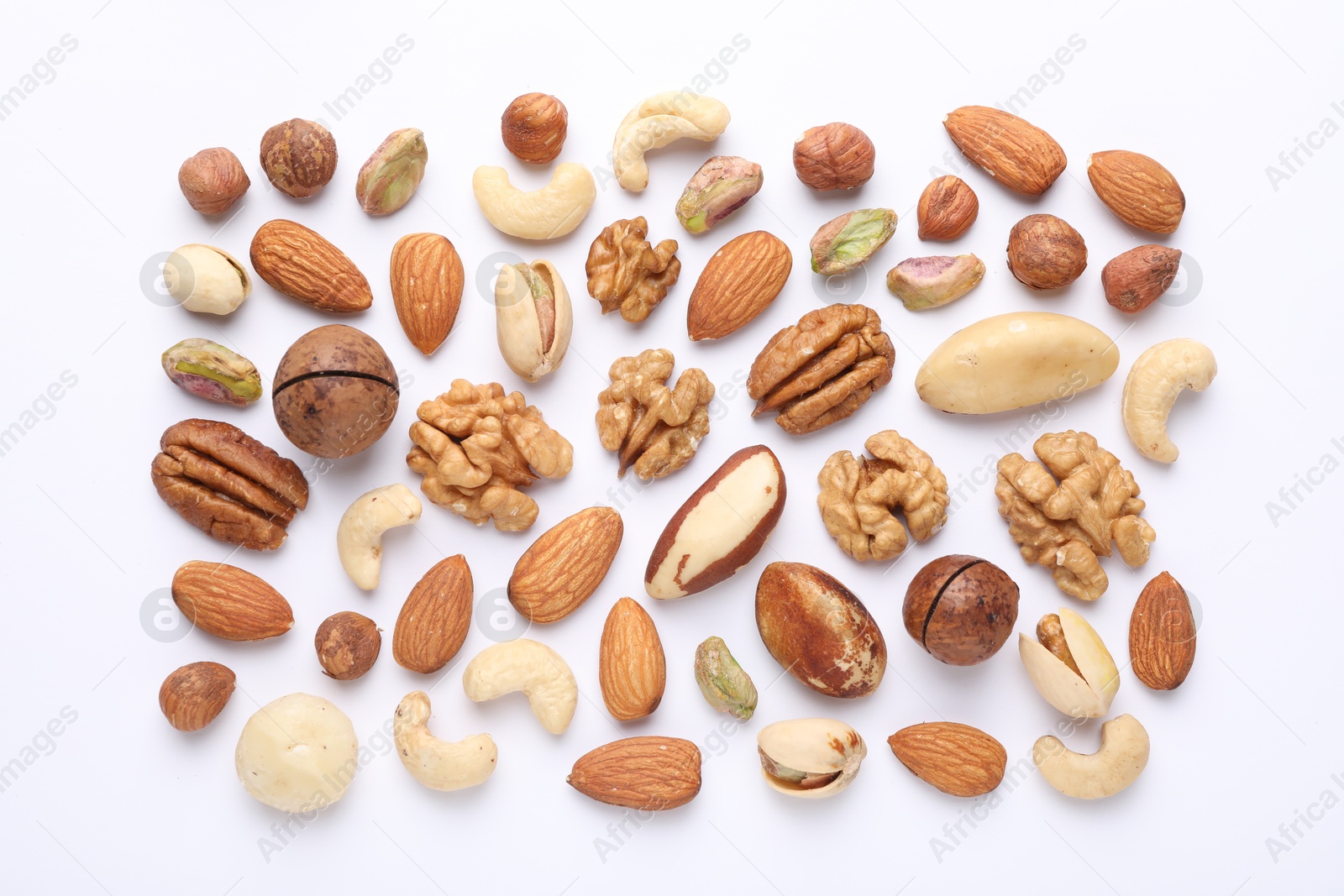 Photo of Mix of different nuts on white background, flat lay