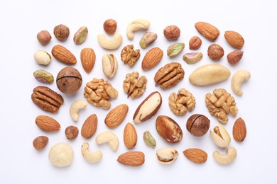 Photo of Mix of different nuts on white background, flat lay