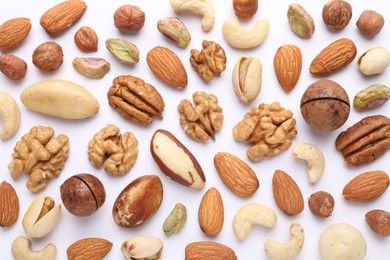 Photo of Mix of different nuts on white background, flat lay