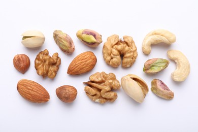Photo of Mix of different nuts on white background, flat lay
