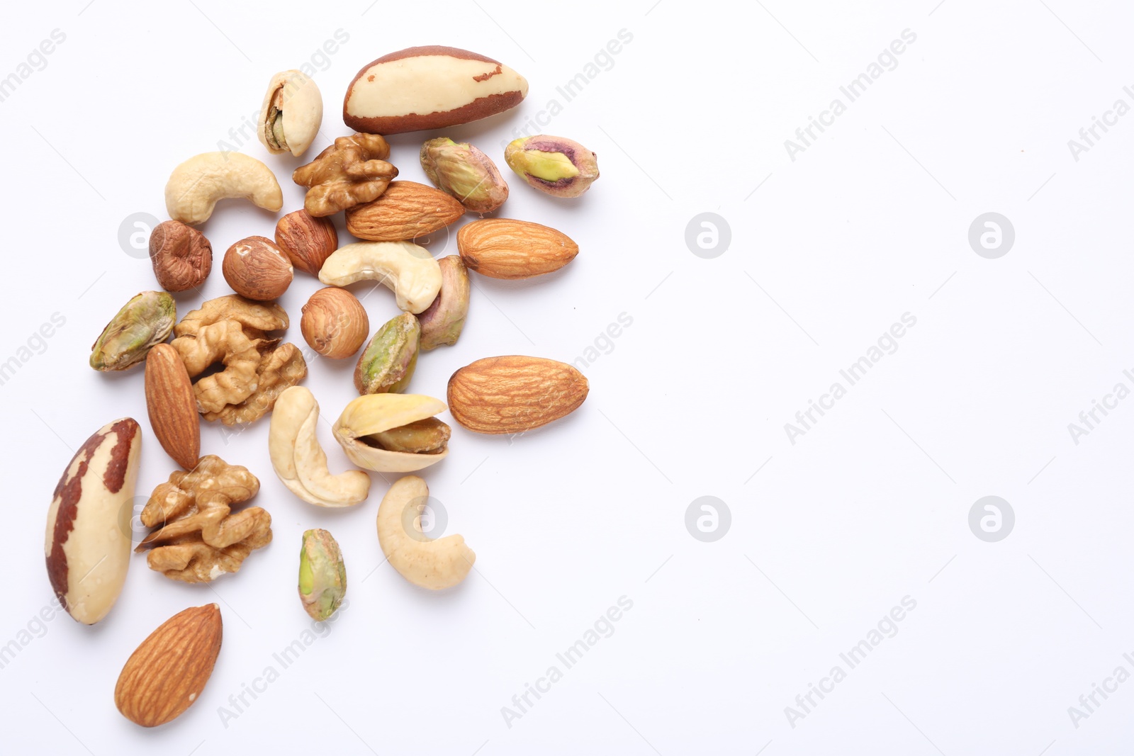 Photo of Mix of different nuts on white background, flat lay. Space for text