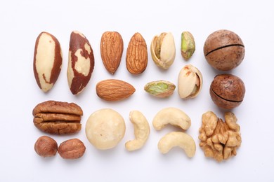 Photo of Mix of different nuts on white background, flat lay