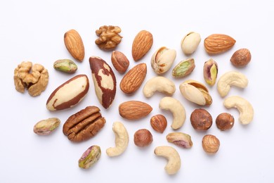 Photo of Mix of different nuts on white background, flat lay