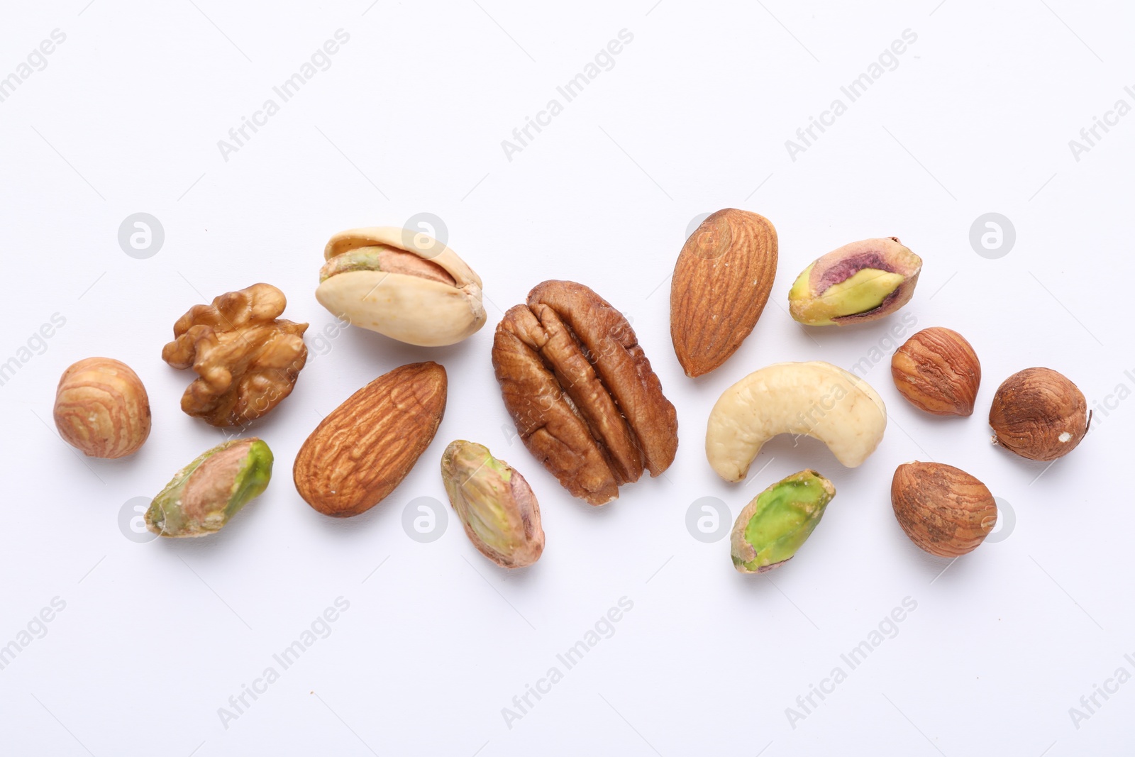 Photo of Mix of different nuts on white background, flat lay