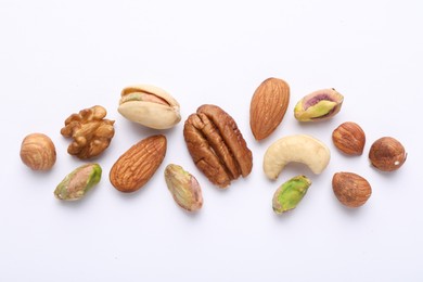 Photo of Mix of different nuts on white background, flat lay