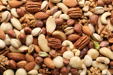 Photo of Mix of different nuts as background, closeup