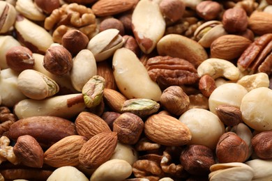 Photo of Mix of different nuts as background, closeup