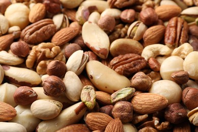 Photo of Mix of different nuts as background, closeup