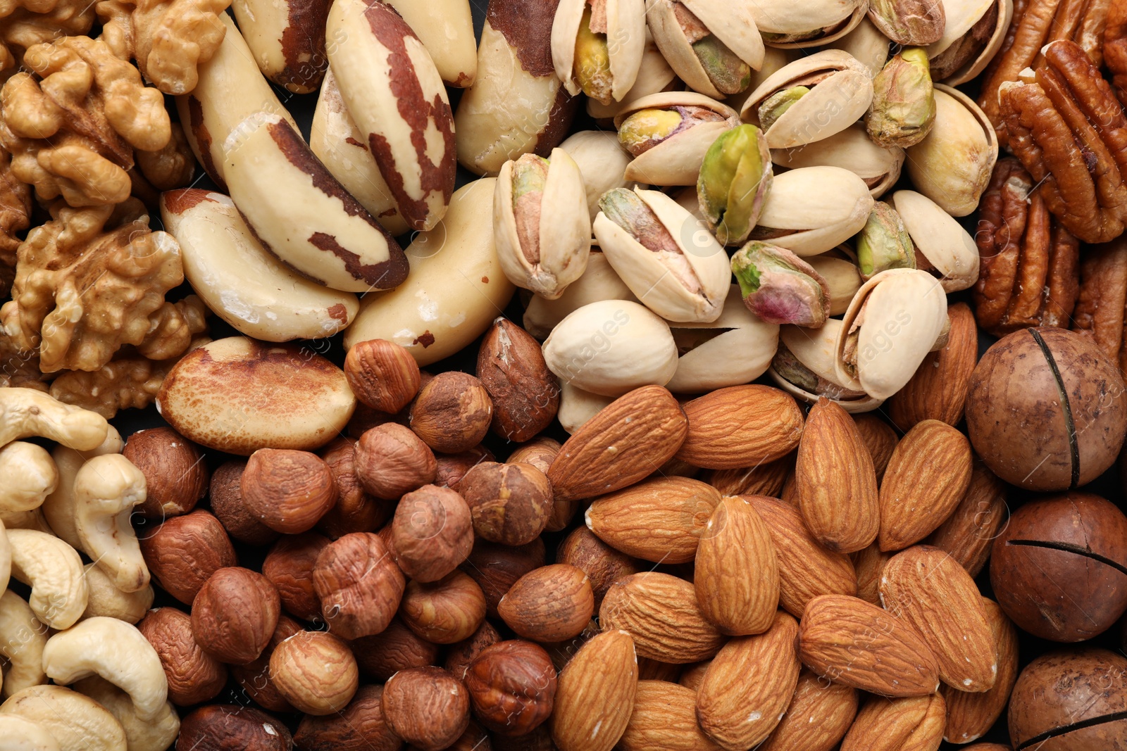 Photo of Mix of different nuts as background, closeup