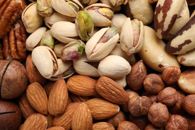 Photo of Mix of different nuts as background, closeup