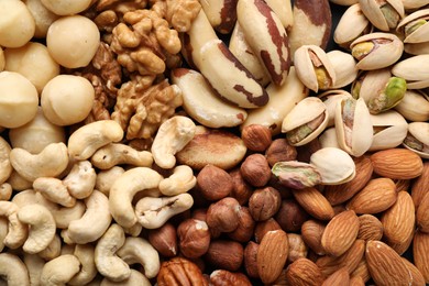 Photo of Mix of different nuts as background, closeup