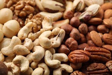 Photo of Mix of different nuts as background, closeup