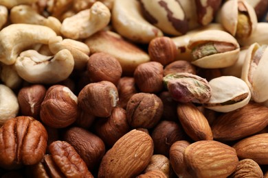 Photo of Mix of different nuts as background, closeup