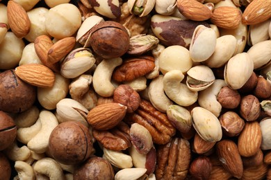 Photo of Mix of different nuts as background, closeup