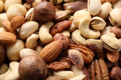 Photo of Mix of different nuts as background, closeup