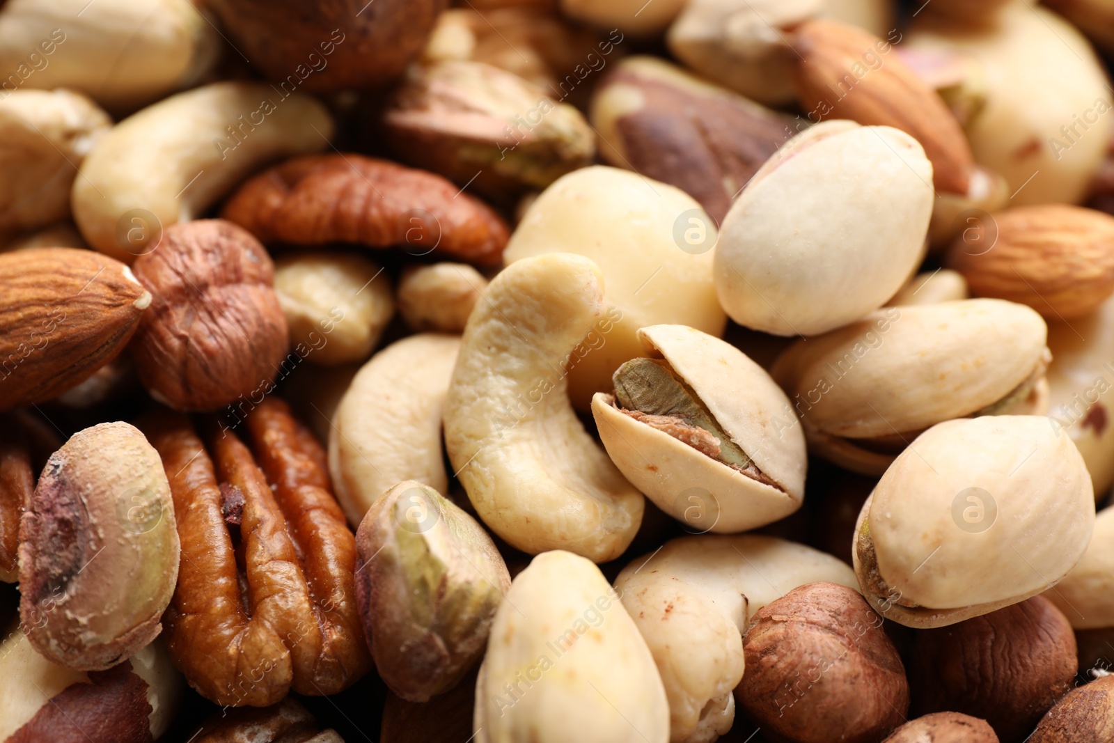 Photo of Mix of different nuts as background, closeup