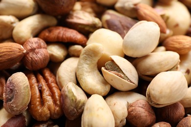 Photo of Mix of different nuts as background, closeup