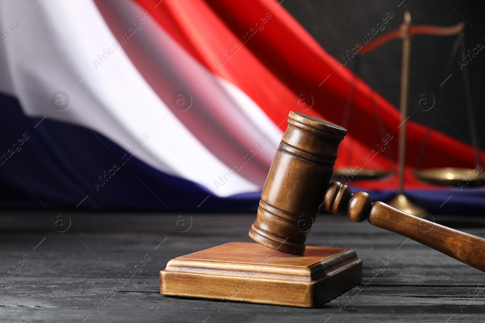 Judge's gavel, flag of France and scales on black wooden table, closeup. Space for text Photo of Judge's gavel, flag of France and scales on black wooden table, closeup. Space for text