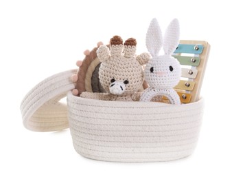 Photo of Different toys in wicker basket isolated on white
