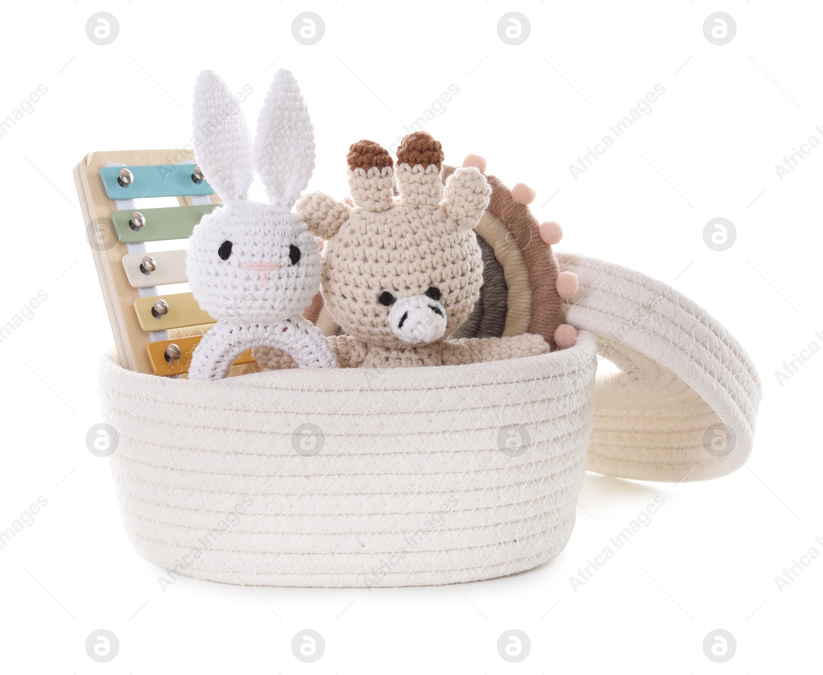 Photo of Different toys in wicker basket isolated on white