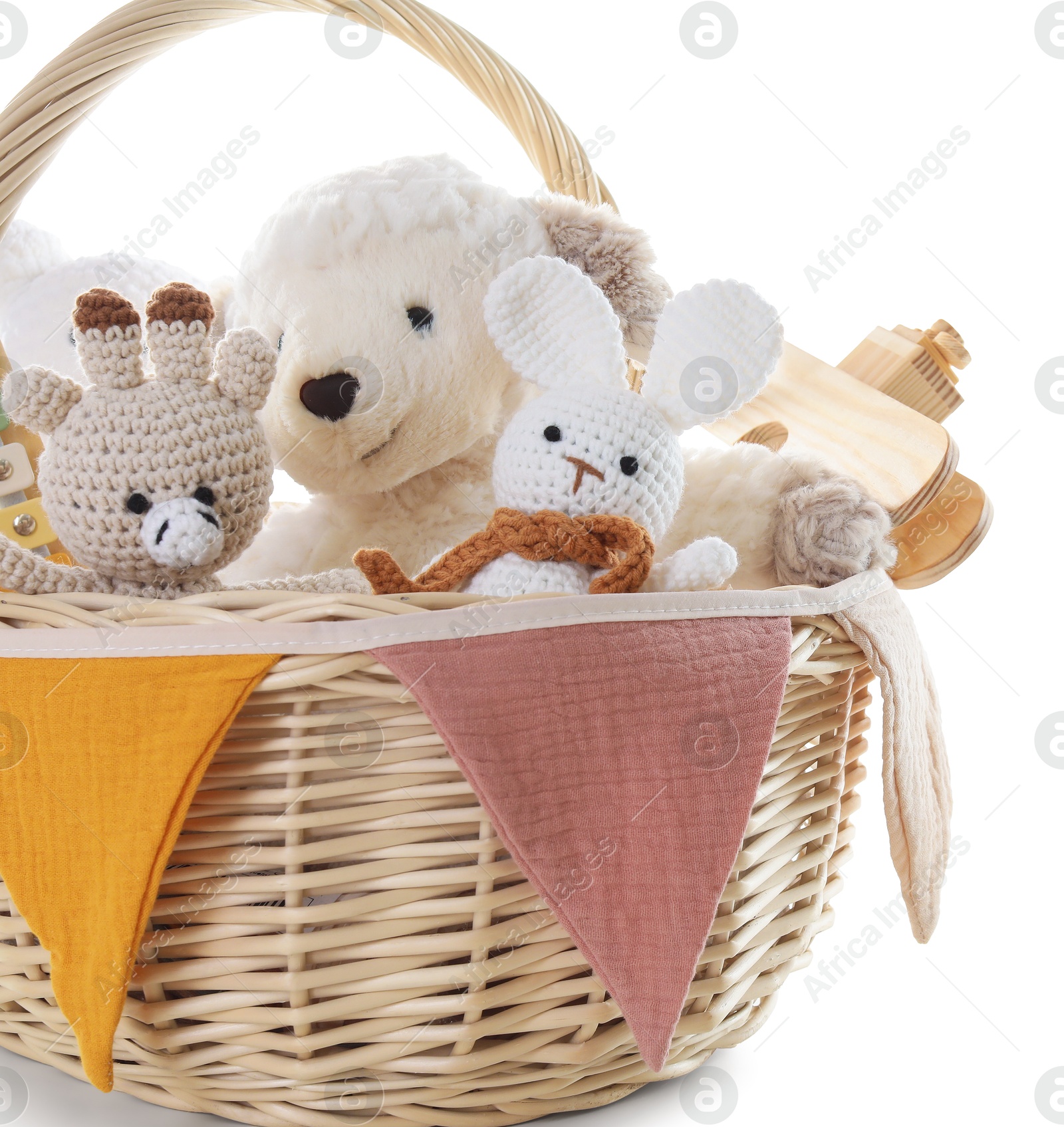 Photo of Different toys in wicker basket isolated on white