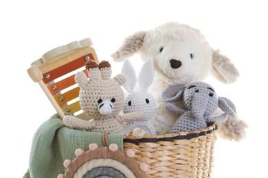 Photo of Different toys in wicker basket isolated on white