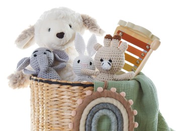 Photo of Different toys in wicker basket isolated on white